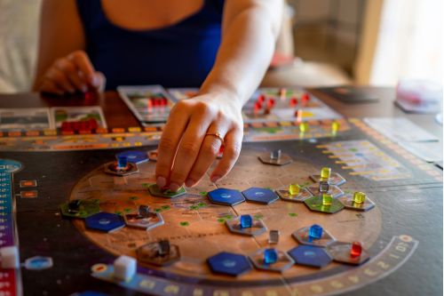 Texas Tabletop Games Woman Playing Board Game in Dallas Cafe