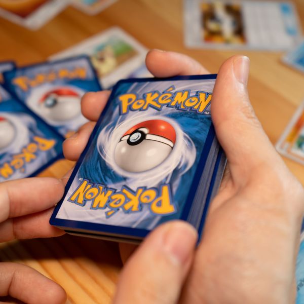 A deck of Pokemon cards being held mid-game.